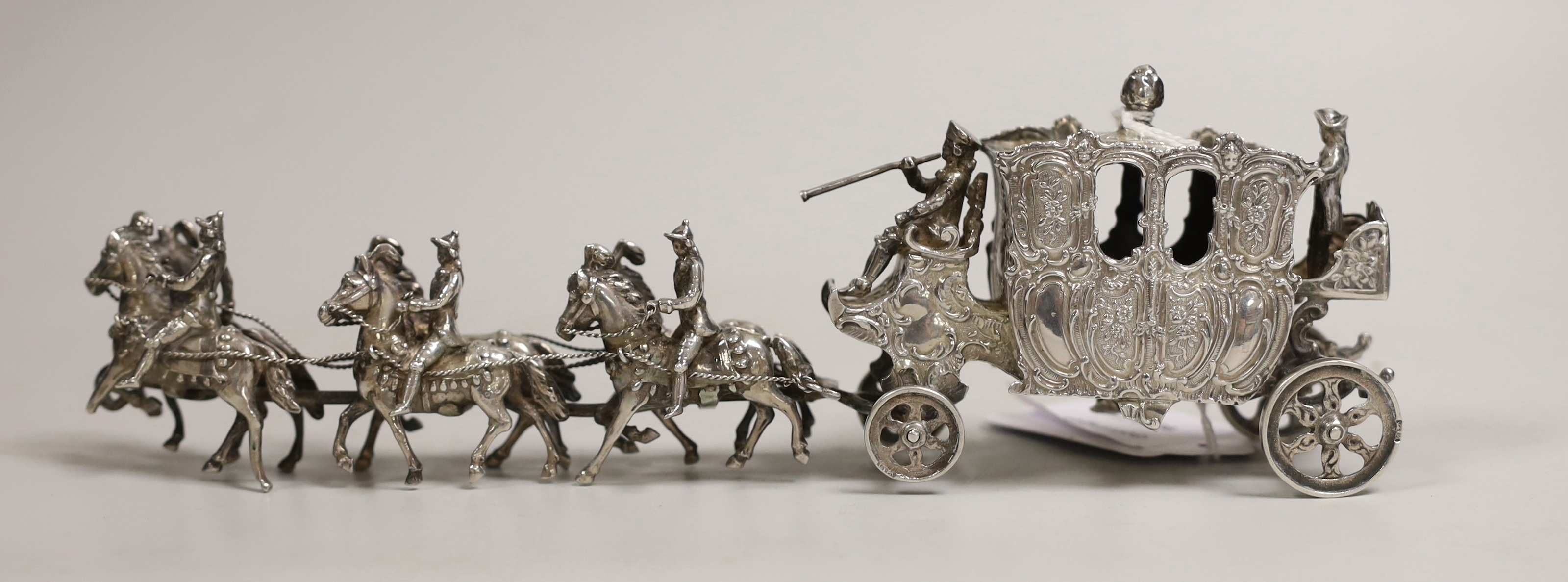 An Edwardian Hanau silver model of a coaching procession, import marks for London, 1901, length 24cm, 10.9oz.